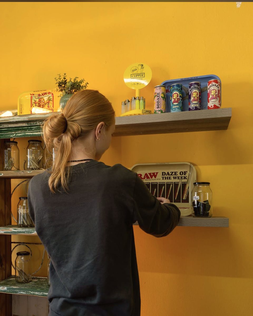 A member of the Herb Heaven team at the counter